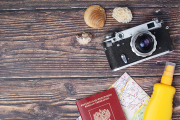 A vintage camera, map and sunscreen cream as a traveling essentials