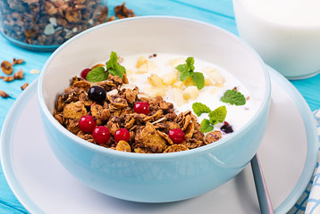 Breakfast. Bowl of homemade granola with yogurt and fresh berries. Table setting. Healthy food.