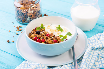 Breakfast. Bowl of homemade granola with yogurt and fresh berries. Table setting. Healthy food.