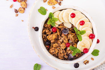 Breakfast. Bowl of homemade granola with yogurt and fresh berries. Table setting. Healthy food. Top view.