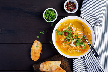 Red lentil soup with chicken meat and vegetables close-up on the table. Healthy food. Top view