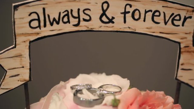 A slider shot of wedding rings, wth a focus reveal.