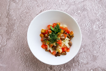 Vegetarian salad with mushrooms, cabbage, tomato and croutons