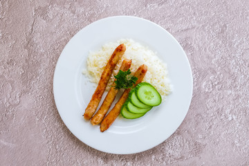 Fried sausage with mashed potato and fresh cucumber