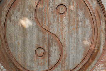Yin-Yang symbol carved on wooden door