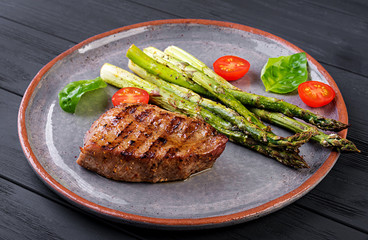 Barbecue grilled beef steak meat with asparagus and tomato.