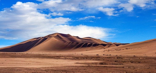 Golden sand dune 7 and white clouds on a sunny day