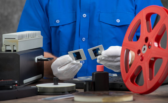 technician with white gloves digitizing old 35mm film slide