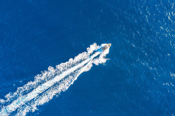 Boat launch at high speed floats in the Mediterranean, aerial top view.