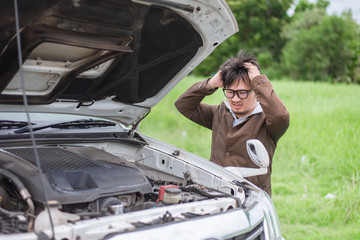 man with broken car