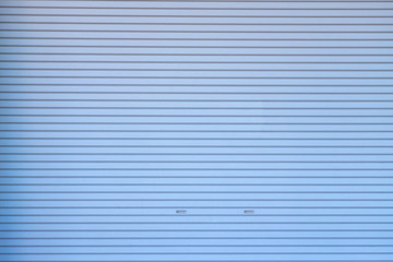 Metal roller shutter door or gate wall closed background.