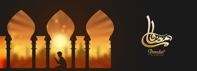 Arabic Islamic calligraphy text of Ramadan Kareem with silhouette of a muslim boy Praying (Offering Namaz) on burgundy background for header banner or poster design.