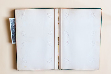 Old photo album with open page with frames and  photos. Top view.