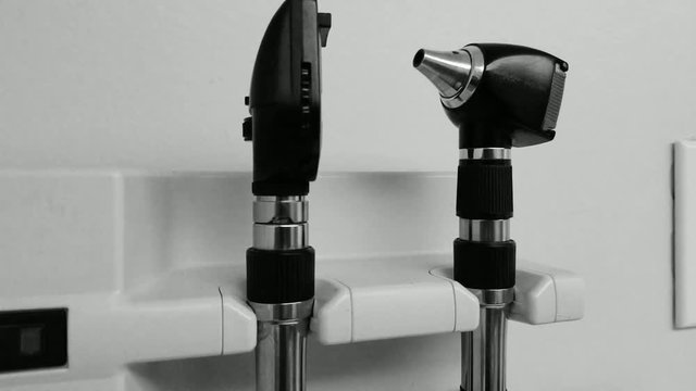 Otoscope medical intrument hanging on the wall of a doctor's office. Pediatrician or any other health care visit. Shot in 4k