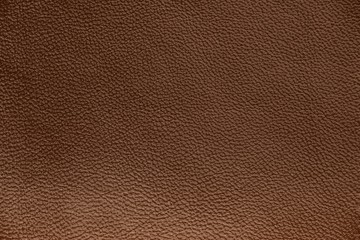 The texture of genuine leather. Impeccable and stylish background.  Beautiful stylish background. Natural skin texture close up. Brown background.  The structure of the leather material brown shades.