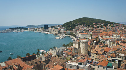 Fototapeta na wymiar Aerial view of coast and roofs from the bell tower, beautiful cityscape, sunny day, Croatia Adriatic sea, Split, Croatia