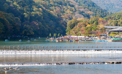 Beautiful landscape of Katsura River and surrounding mountains in autumn of Japan, Arashiyama is an extremely popular tourist spot visitors to Kyoto, Japan © Nischaporn