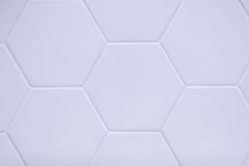 real photo of white hexagonal tiles wall of the bathroom