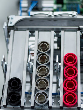 closeup of a vertical storage rack of a smart factory. Products which are placed according to color. Industry 4.0 concept, smart factory manufacturing line is equipped with sensors.