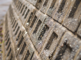 Closeup stone wall textured in shallow depth of field. Abstract background with selective focus.