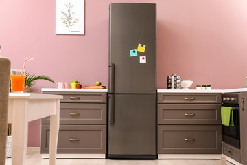 Big modern fridge in interior of kitchen