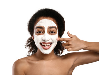 Young African-American woman with mask on her face against white background
