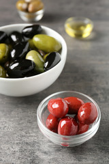 Tasty olives on grey table