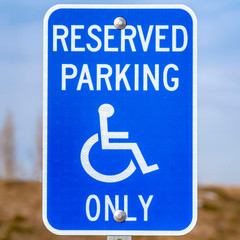 Clear Square Blue Reserved Parking Van Accessible sign with a man on a wheelchair icon