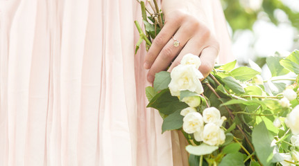 Spring engagement woman hand with a ring and spring flowers	