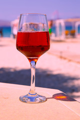 A glass of wine on the beach, summer beach relax concept. 