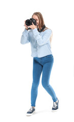 Young female photographer on white background