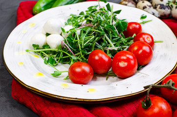 Fresh salad with chicken breast, arugula and tomato.