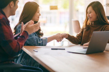 Three asian businessman working and shaking hands in a meeting
