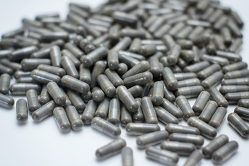 Set of grey capsules pills on white background. Medical preparations.