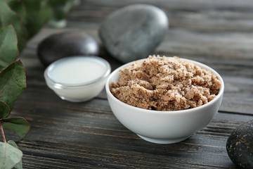 Bowl with body scrub on table