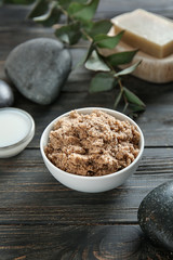 Bowl with body scrub on table