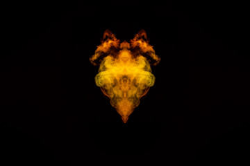 Abstract image of smoke of different green, yellow, orange and red colors in the form of horror in the shape of the head, face and eye on a black isolated background. Soul and ghost in mystical symbol