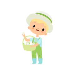 Cute Boy in Overalls, Rubber Boots and Hat with Basket of Fresh Eggs, Young Farmer Cartoon Character Engaged in Agricultural Activities Vector Illustration