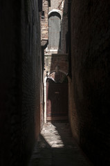 dark alley with sunrays in Venice