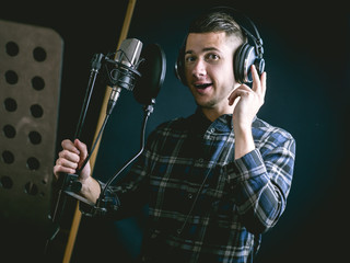 The young guy singing in recording studio
