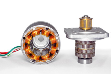 Stepper motor, disassembled, with the rotor set aside Stepper motor with power cable attached, on...