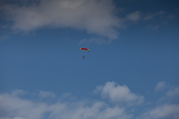 Naklejka na ściany i meble Skydive, people in the sky, under clouds