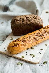 Freshly baked white and grey bread on dark grey fabric with seed