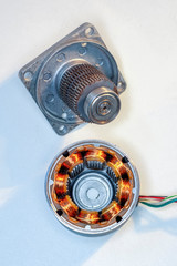 Stepper motor, disassembled, with the rotor set aside Stepper motor with power cable attached, on...