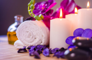 Obraz na płótnie Canvas Beautiful spa image with seashell place for relaxation orchid flower and burning candles colorful spa massages center
