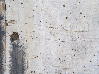 The old gray plaster is covered with cracks, scratches.