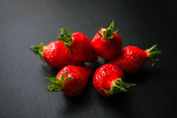 Group of delicious strawberrys on black background