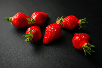 Group of delicious strawberrys on black background