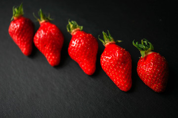 Group of delicious strawberrys on black background