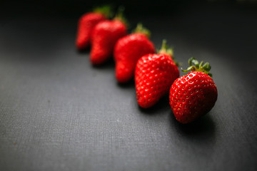 Group of delicious strawberrys on black background